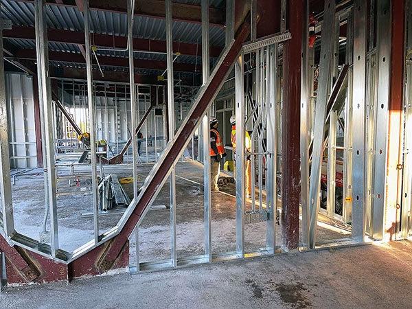 interior of a building under construction with steel stud framing and steel brace frames