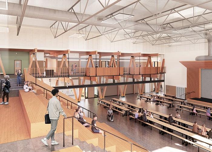 a large open 2 story interior space looking down over learning stairs to the floor with lunchtables