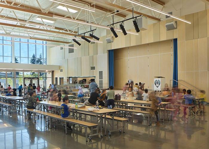 a lunchroom with students at tables